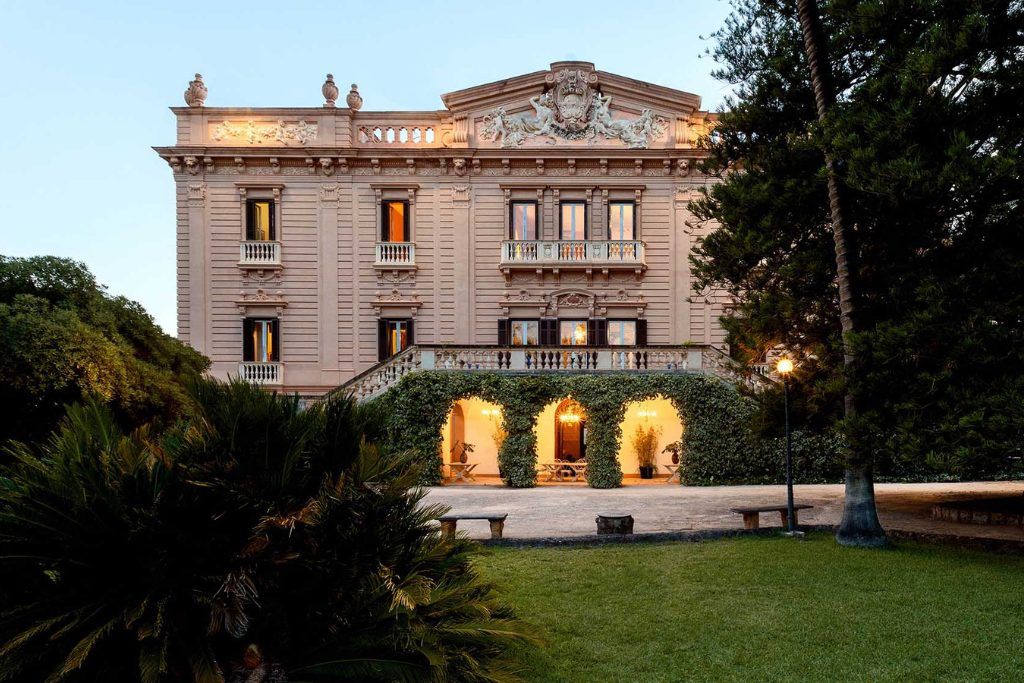 The exterior of the Villa Tasca at dusk.