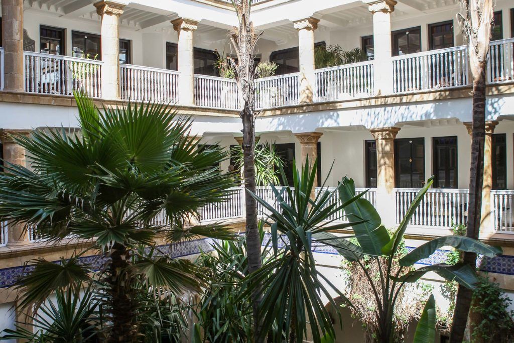The lobby of the Heure Bleu Palais with greenery in the corner.