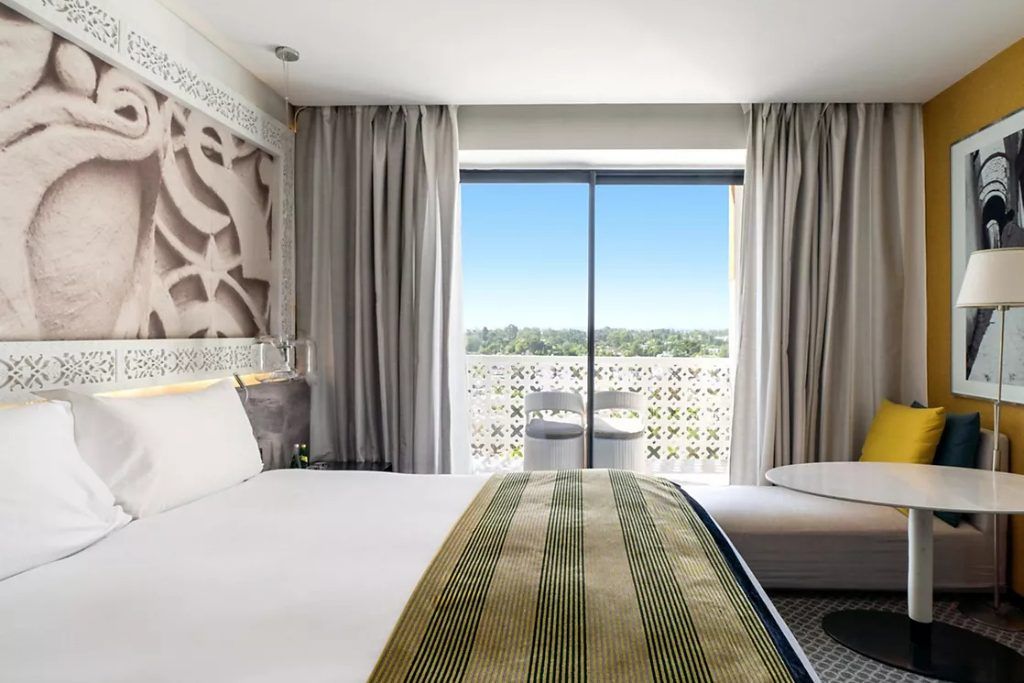 One of the bedrooms and a large window at the Sofitel Rabat Jardin des Roses.