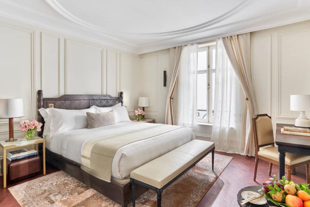 One of the rooms with long drapes and a king bed at the Mandarin Oriental Ritz in Madrid.