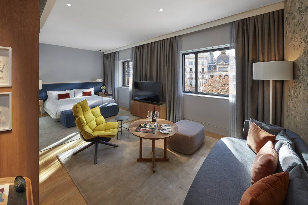 One of the spacious rooms in the Mandarin Oriental in Barcelona with a lounge area and large bed.