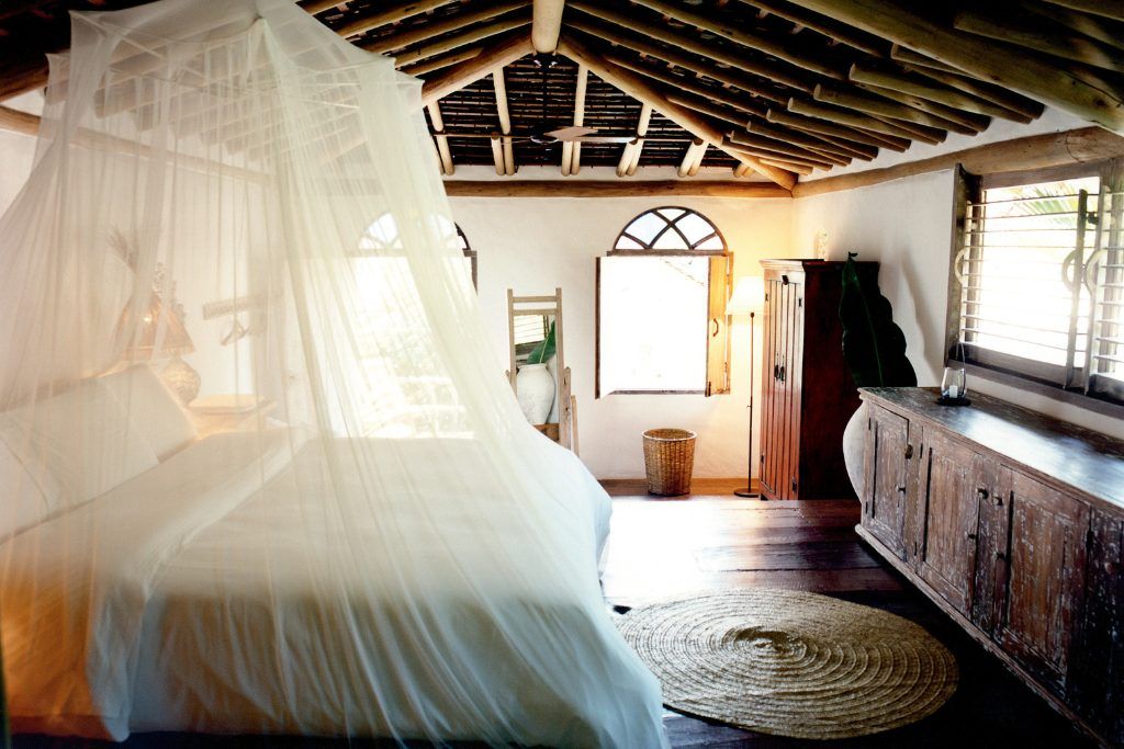 A bed with a canopy over it in a private room in UAXA Casa Hotel.