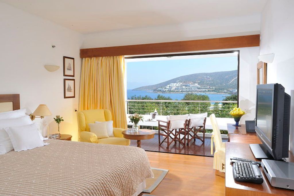 A room at Elounda Beach Hotel overlooking the water.