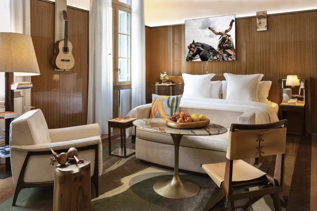 A view of one of the rooms at the Rosewood Sao Paulo with a bed and small lounge.
