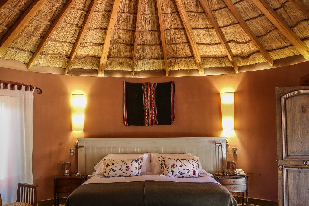 A front-on view of a bed in one of the private rooms in Awasi Atacama.