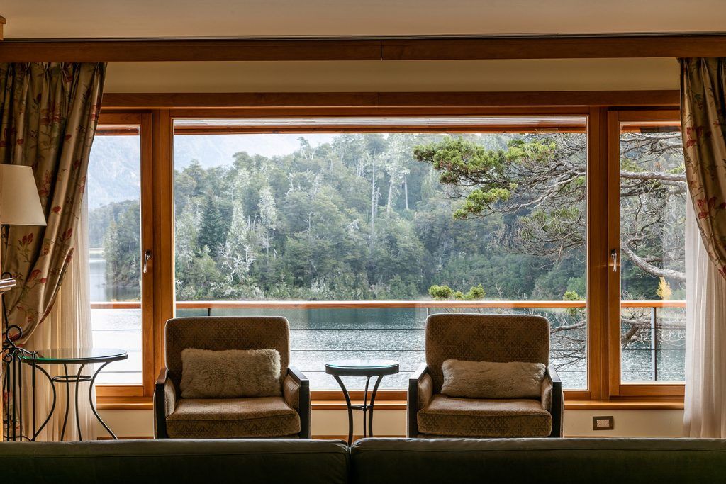 The lounge next to a large lakefront window at the Llao Llao resort.