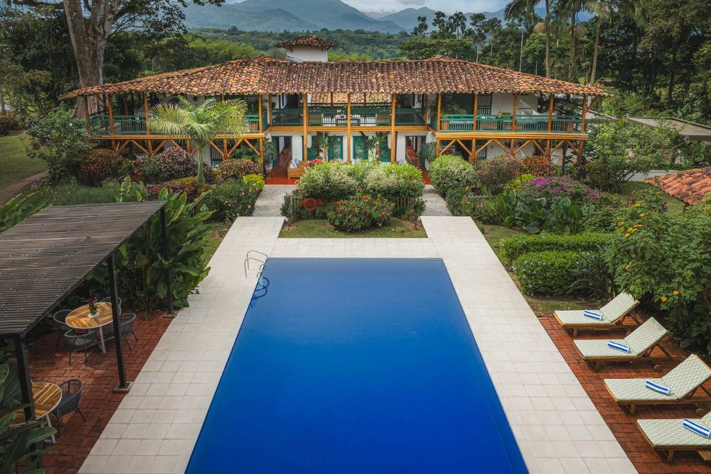 The large swimming pool and the exterior of Hacienda Bambusa.