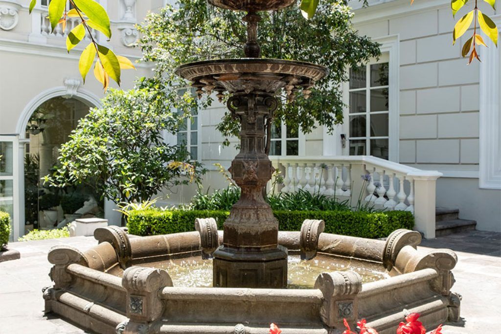 The courtyard at Casa Gangotena with a fountain in the center.