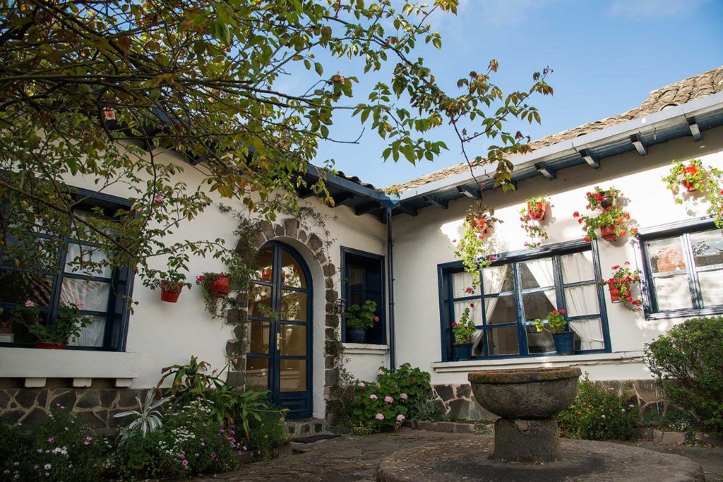 A courtyard in Hacienda Zuleta with a fountain in the center.