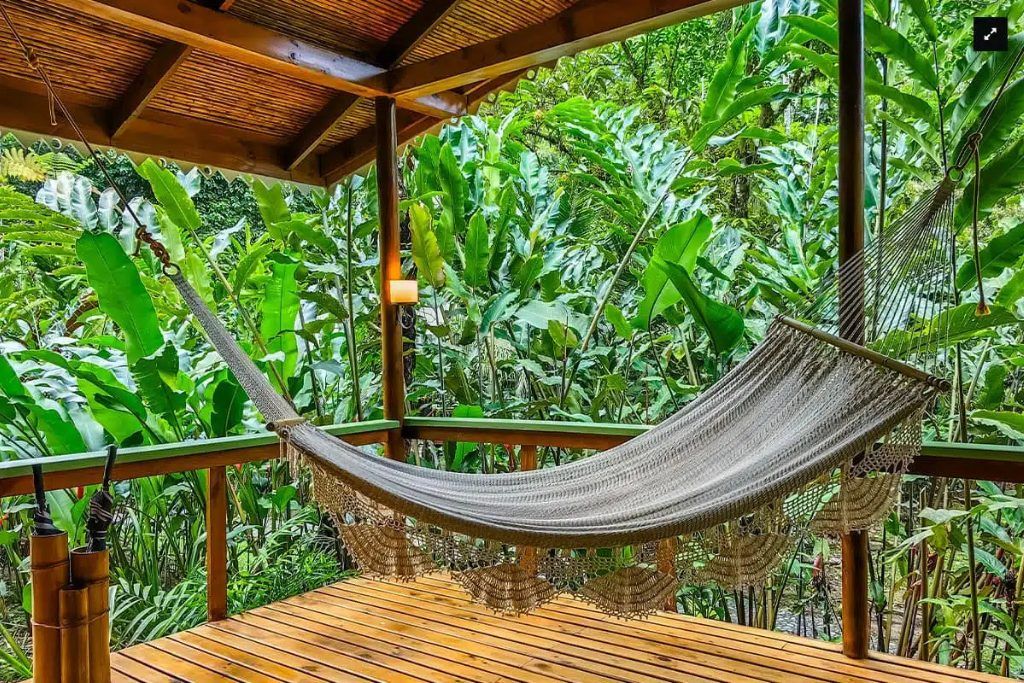 A hammock on the porch of one of the Pacuare River Lodge's rooms.