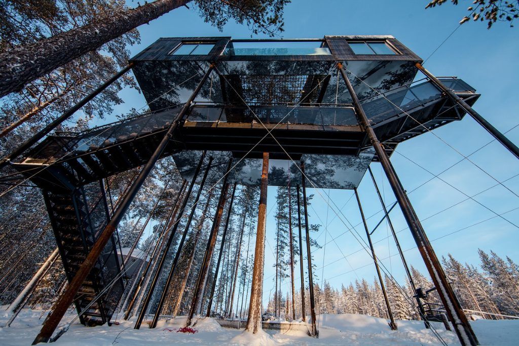 A daytime view looking up at one of the treehouses at the Treehotel in Swedish Lapland.
