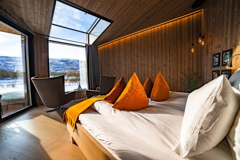 One of the king rooms at Sorrisniva Arctic Wilderness Lodge looking out at the snow.