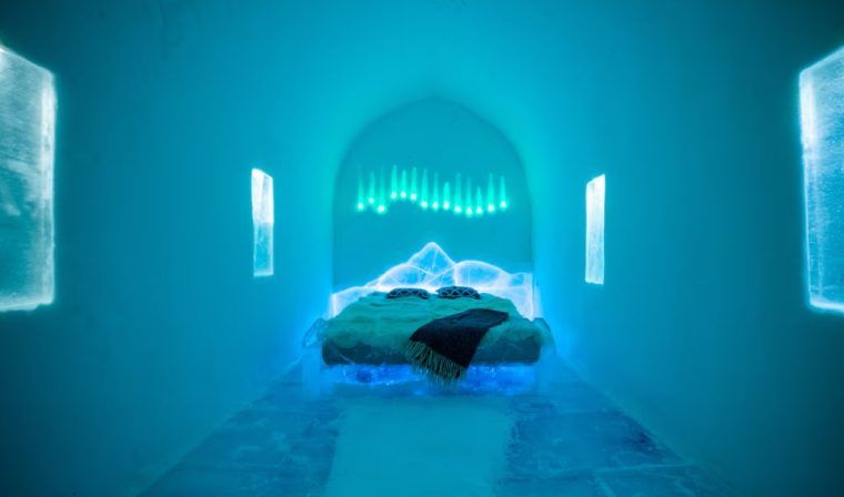 One of the rooms in the Igloo Hotel with furs on the ice bed.