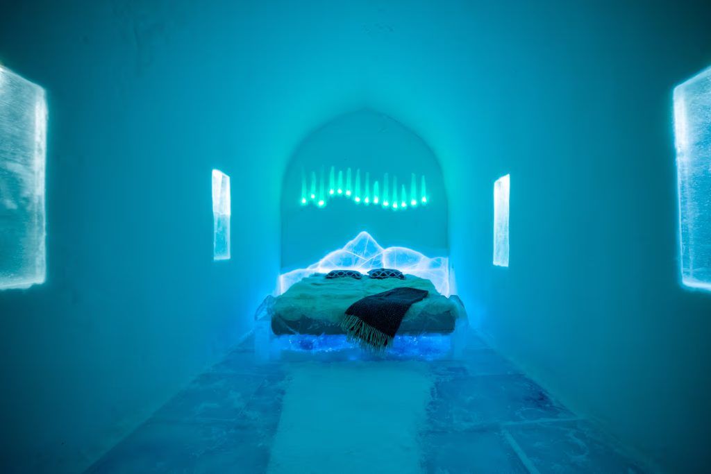 One of the rooms in the Igloo Hotel with furs on the ice bed.