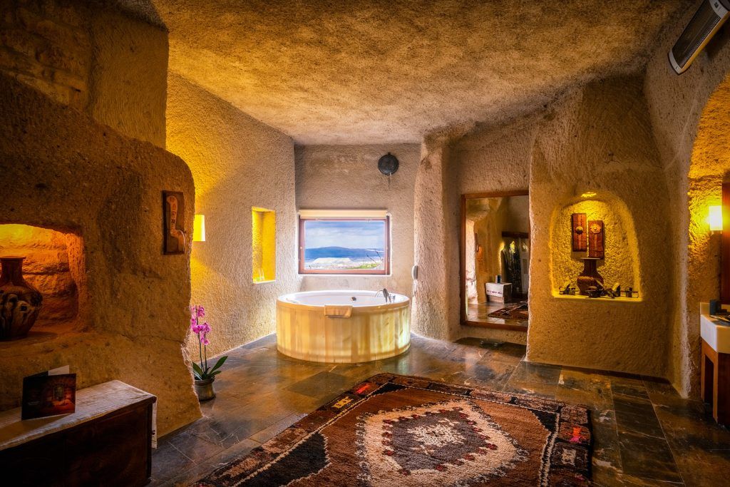 An indoor jacuzzi next to a window at the Museum Hotel in Cappadocia.