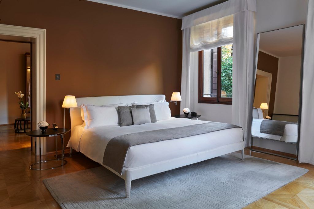 A large king sized bed in a room at the Aman Venice.
