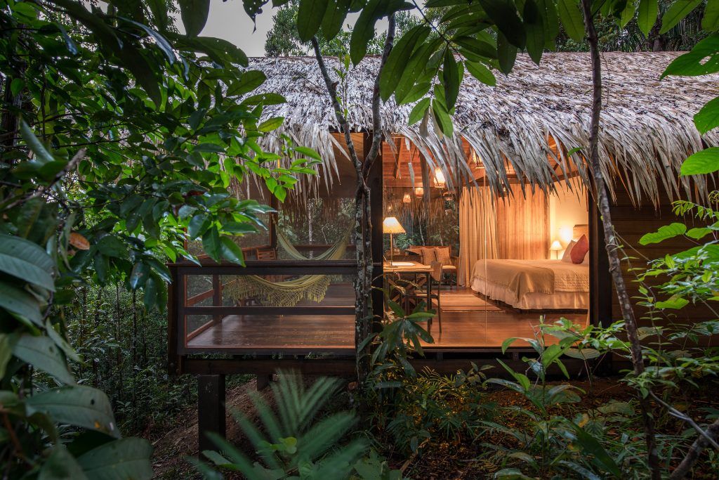 A view of one of the bungalows at Anavilhanas Jungle Lodge with hammocks.