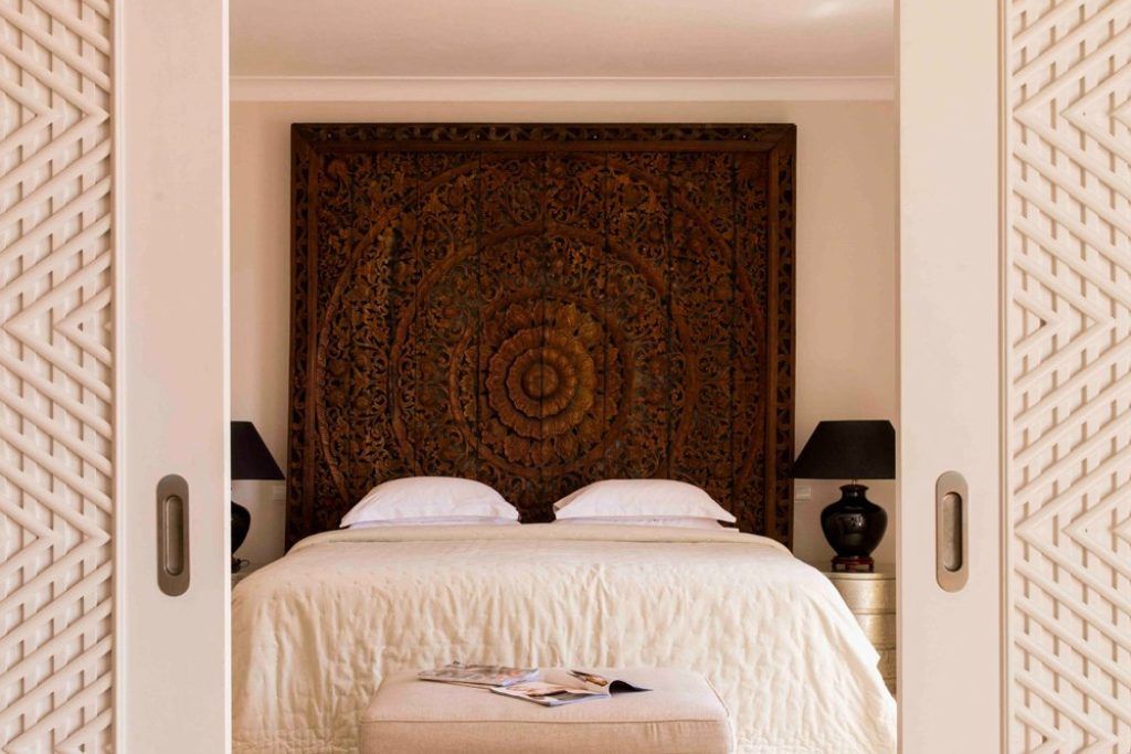 A room with a rich mandala tapestry behind it in Villa Joya.