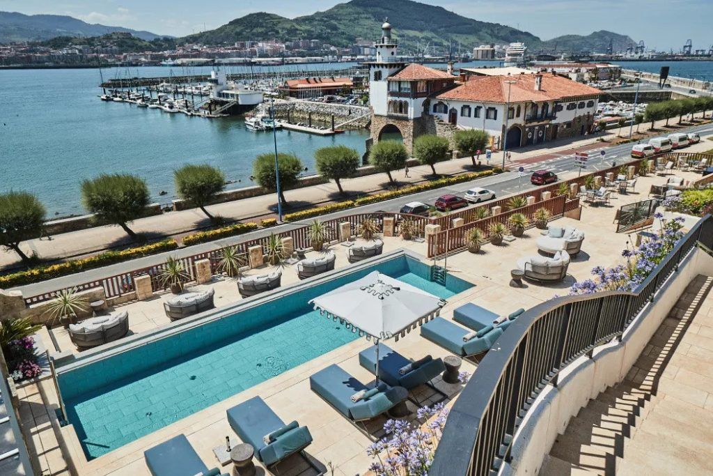 The rooftop pool with loungers at Palacio Arriluce.