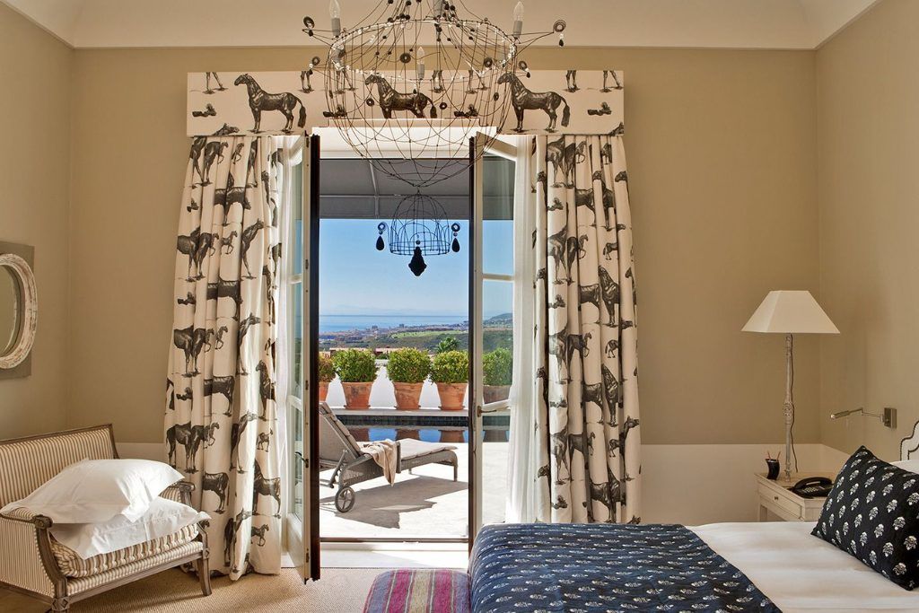 The open balcony door in a bedroom at Finca Hotel Cortesin.