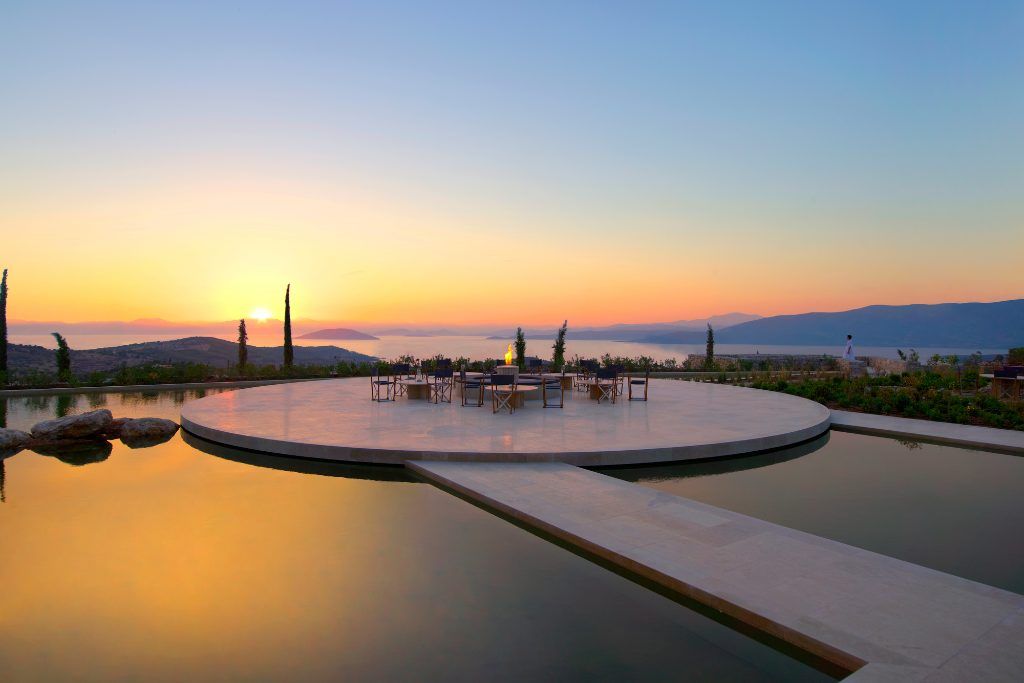 An outdoor patio floating in a pool at Amanzoe.