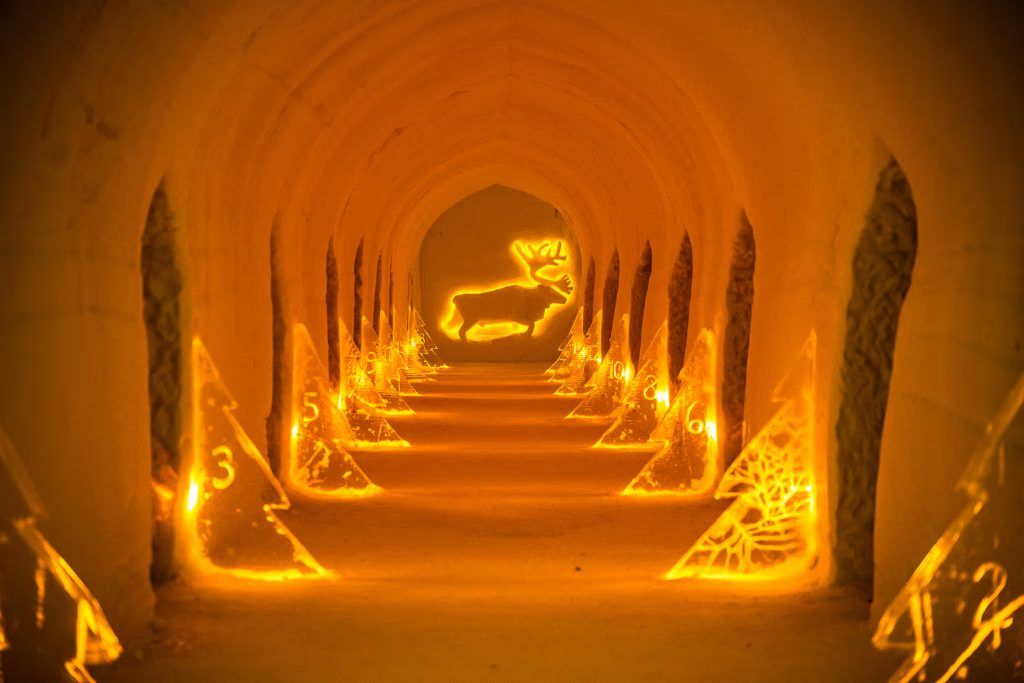 A hallway at the Igloo Hotel with lights along the corridor.