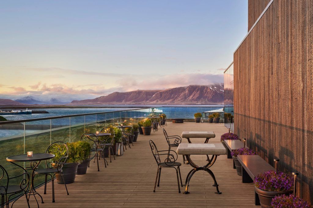 The patio at the Reykjavik EDITION with Mount Esja in the background.