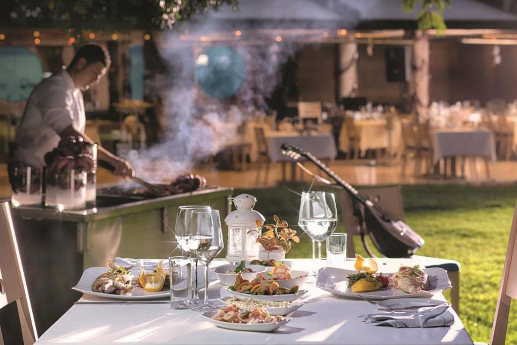 A meal with wine at an outdoor dining area in Swissotel Büyük Efes.