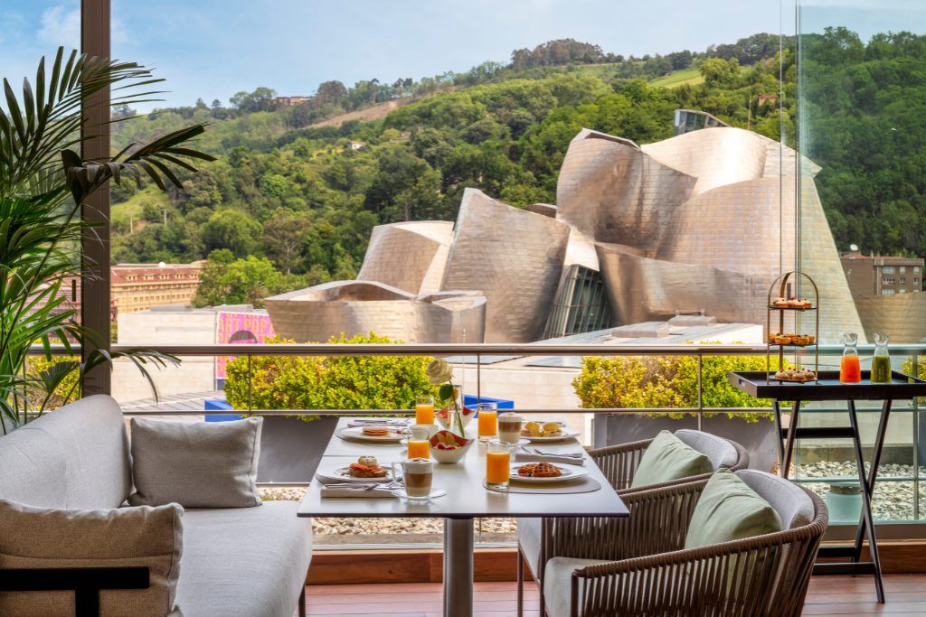 A table set with breakfast on a balcony at The Artist in Bilbao.