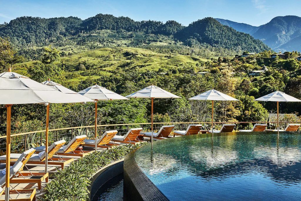 The swimming pool at Hacienda Alta Gracia with loungers looking out over the mountains.