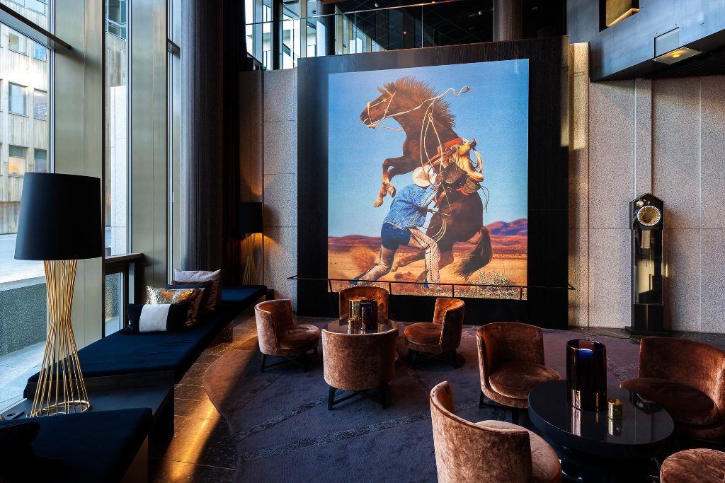 One of the lobby areas in The THIEF hotel in Norway with a large modern art painting.