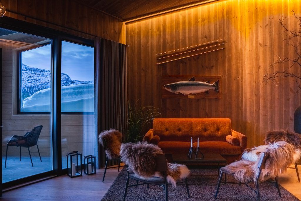 A lounge area with a large window at Sorrisniva Arctic Wilderness Lodge.