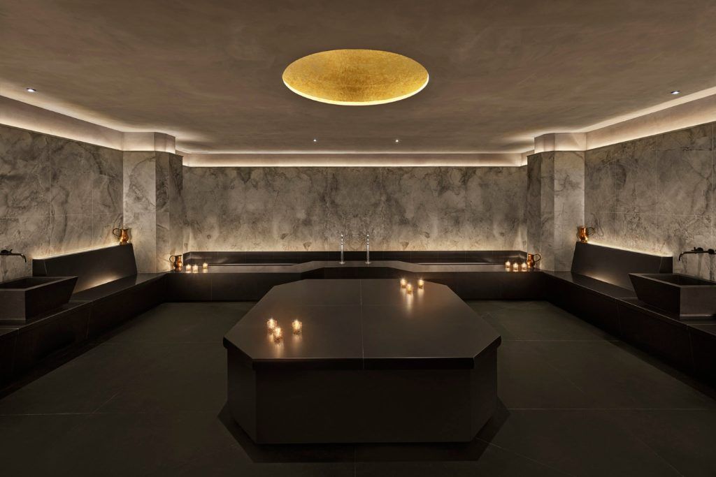 The spa at the Reykjavik EDITION with candles and dark decor.