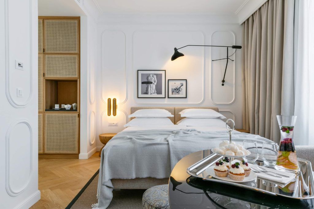 One of the rooms in Hotel Fermai with cupcakes on the side table.