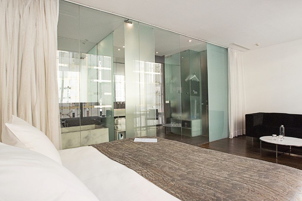 One of the rooms with a large glass mirror and wall at the Hospes Palacio de los Patos