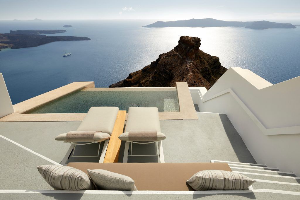 A private plunge pool and loungers on a patio at The Grace Hotel Santorini.