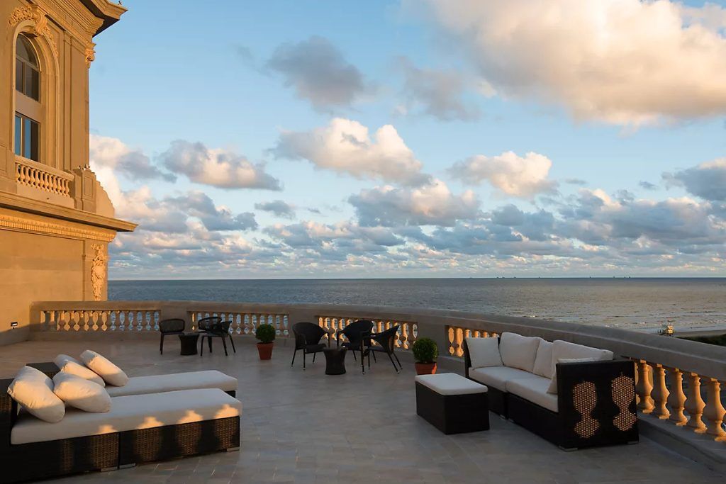 The rooftop bar at the Sofitel Montevideo on a clear day with views of the water in the background.