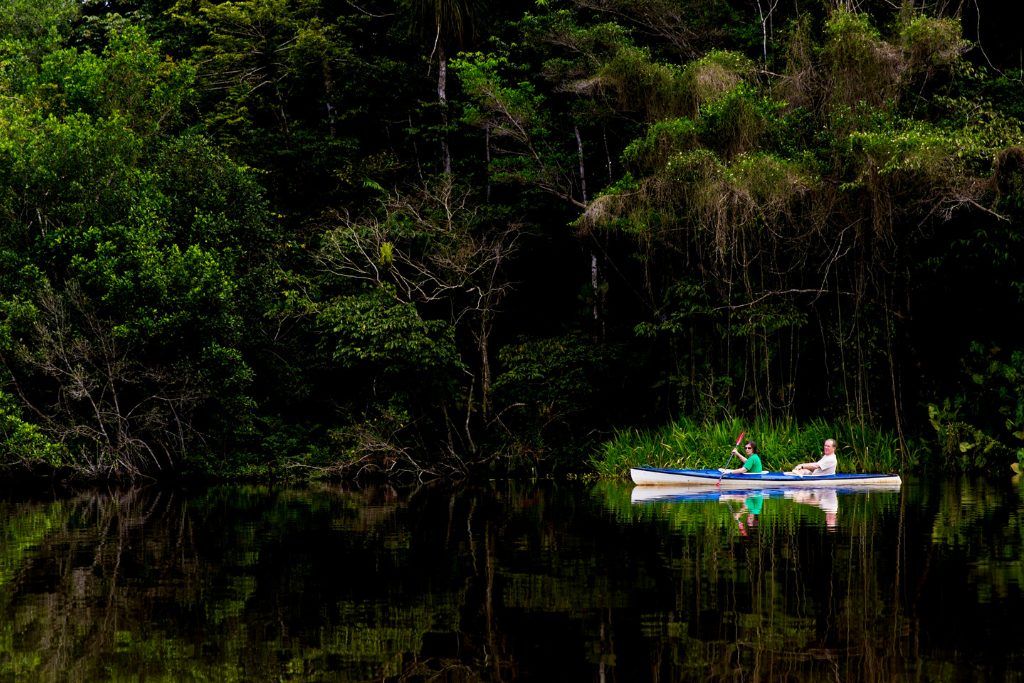 Kayakers in the Amazon River at La Selva Ecolodge.