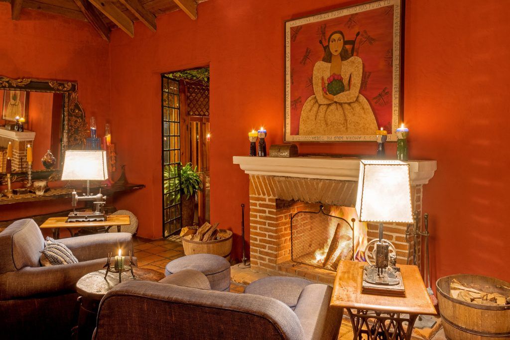 An indoor lounge with a fireplace at Casa Palopo.