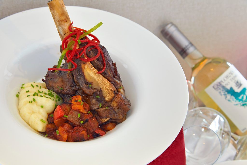 A bottle of wine and beef meal aboard the Magellan Explorer.