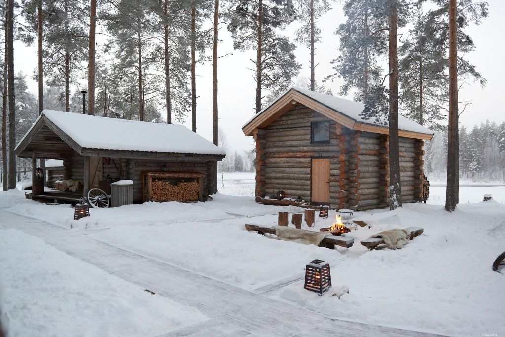 A snowy view of the exterior of the cabins at Arctic Retreat.