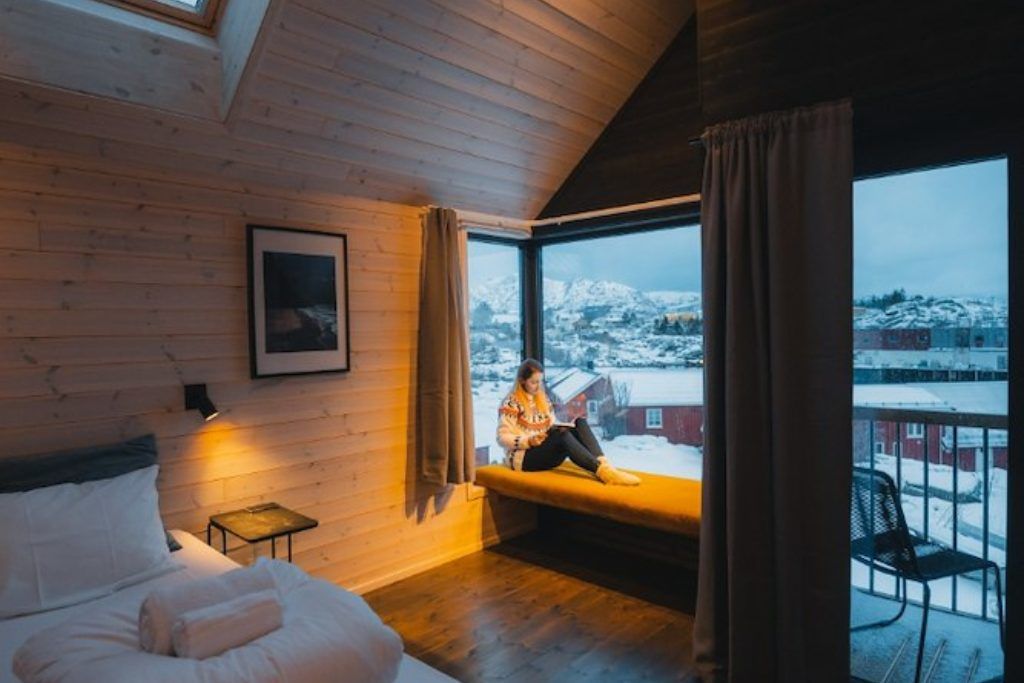 A view from one of the rooms with a reading nook and dim lighting in the Hattvika Lodge.