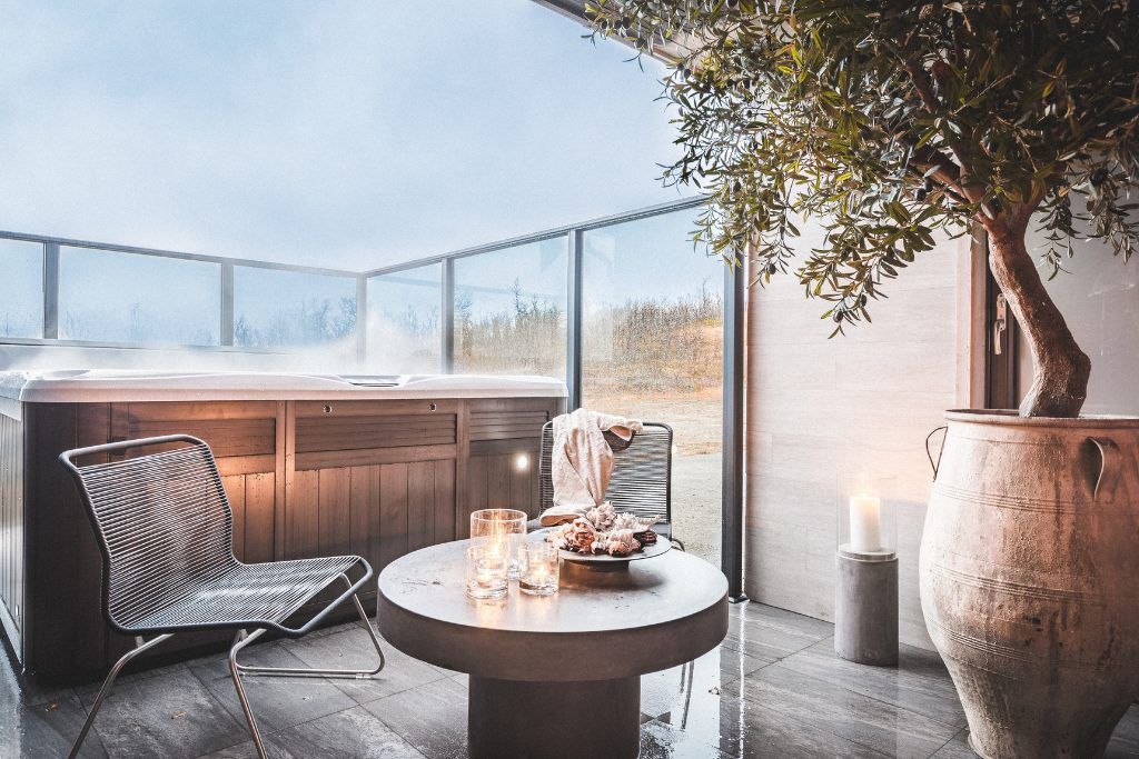 A sunny balcony at Skaret Lodge with a jacuzzi.