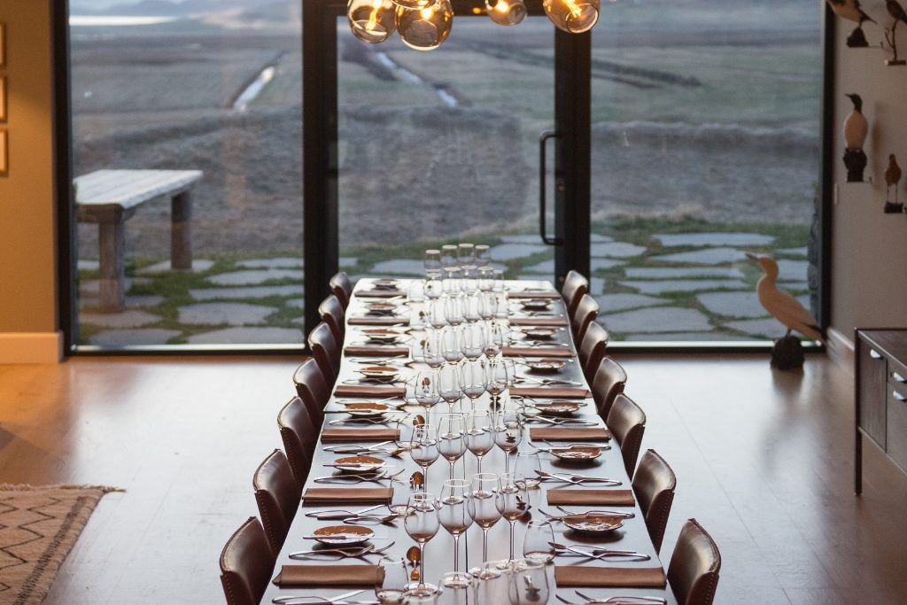 The dining room at Deplar Farm with glasses and tableware set out.