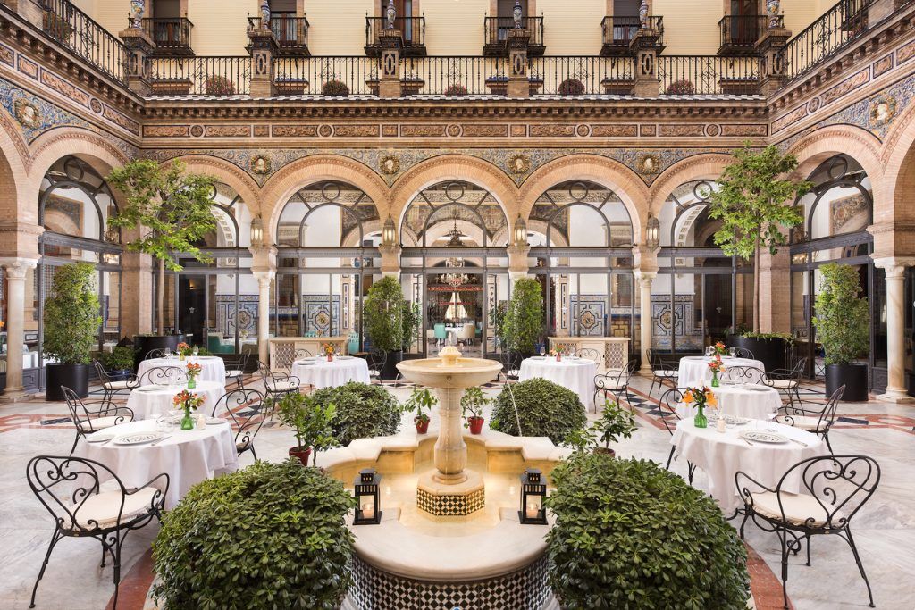 The elegant restaurant at Hotel Alfonso XIII with a fountain in the middle.