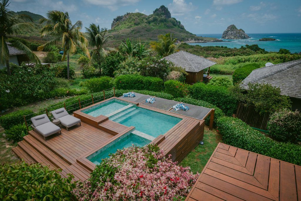Three connected swimming pools at Pousada Maravilha with views over the bay.