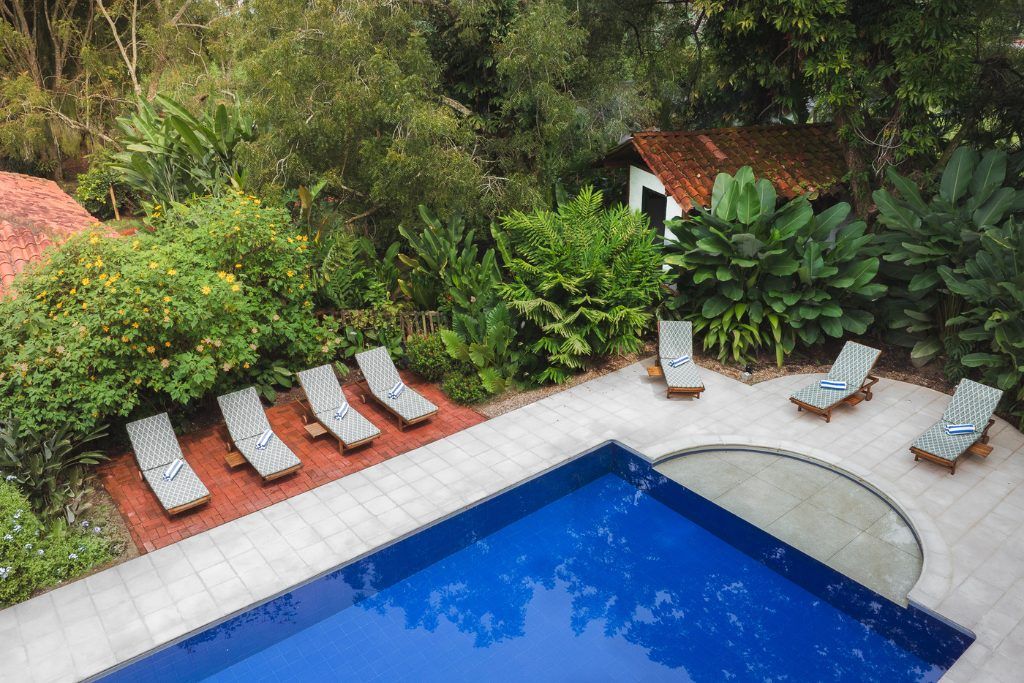 The pool area with loungers at Hacienda Bambusa.