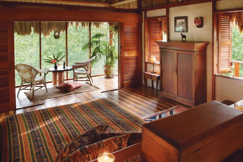 One of the bedrooms with a small sitting room at Blancaneaux Lodge.