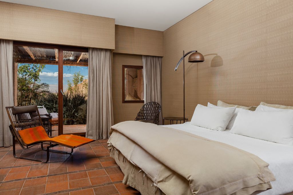 View of bed in luxury suite at Nayara Atacama