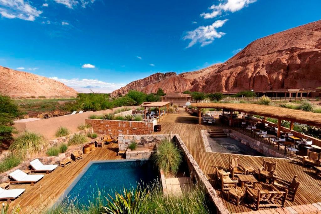 Aerial view of Nayara's outdoor pool and dining area against the backdrop of the Atacama